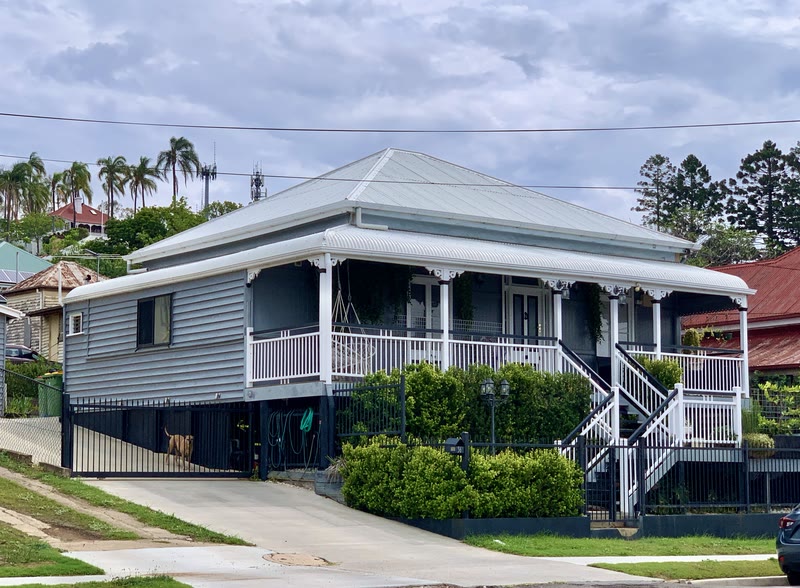 A Queenslander up on its stumps, built for the heat.